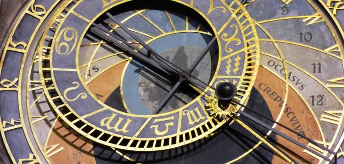 A sundial in gold and navy blue is turning