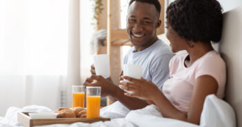 Couple enjoying breakfast in bed on Valentine’s Day