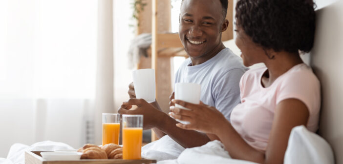 Couple enjoying breakfast in bed on Valentine’s Day